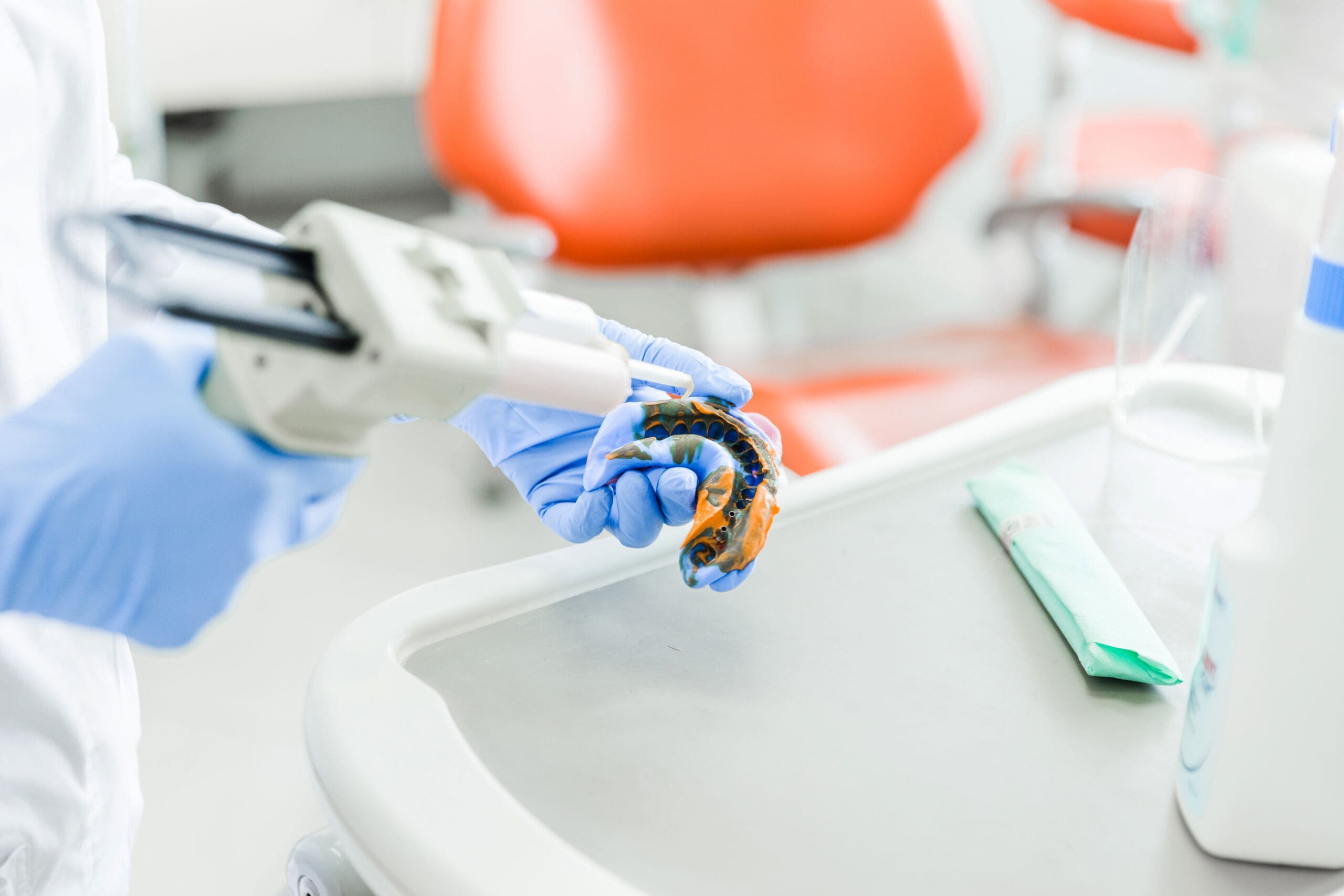 Dentist Preparing Dental Mold with Tool dentist preparing dental mold