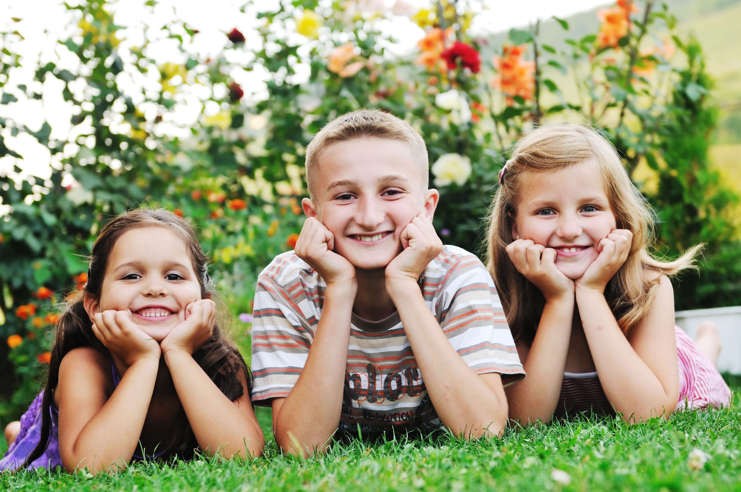 kids smiling on the grass